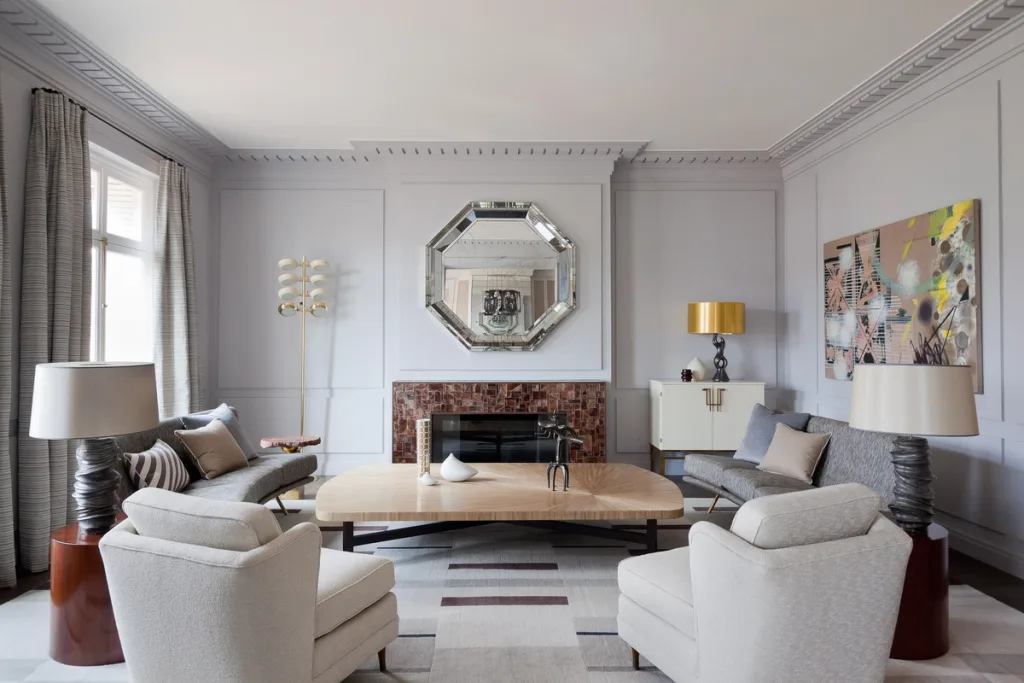 Pale grey living room with an octagonal mirror and curved seating, Jean Louis Deniot, Paris