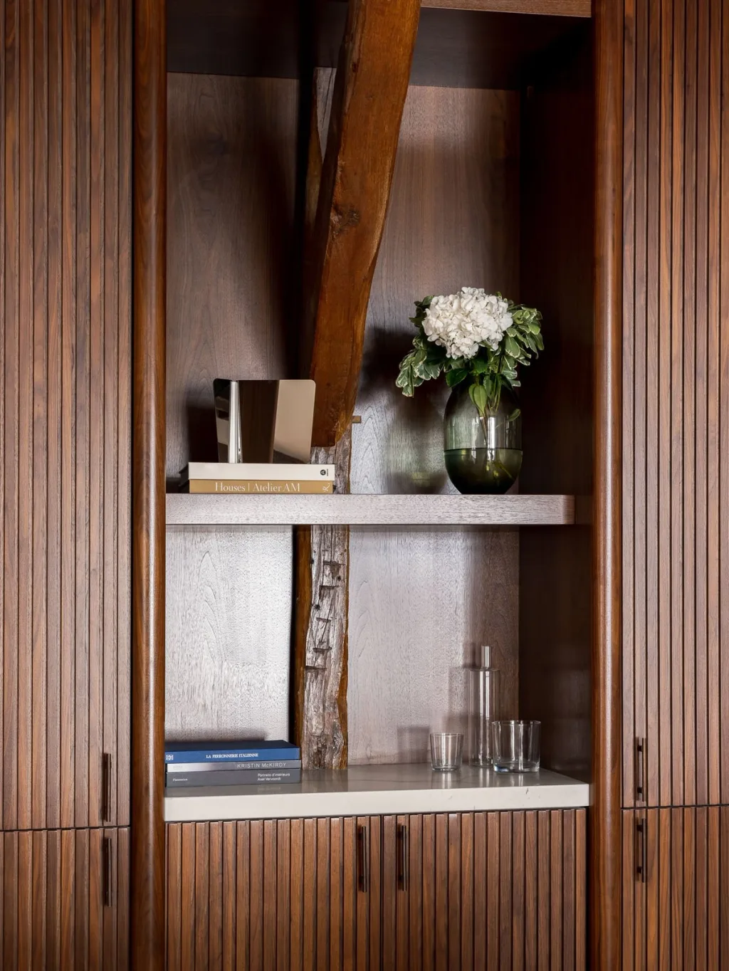 Ribbed wooden cabinet built around an old beam in Hugues de Blignières' Paris interior