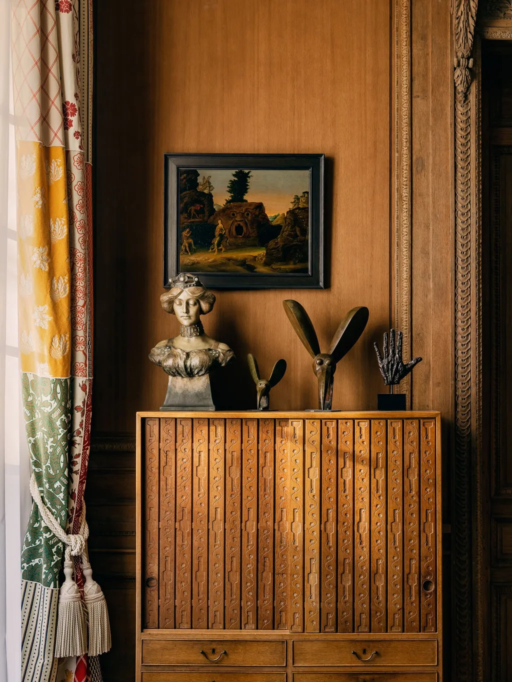 Bust and small sculptures on a patterned cabinet in Laurent Buttazzoni's Paris interior