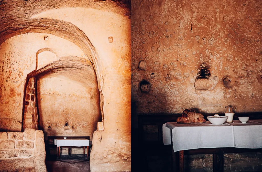 Vaulted stone corridor beside a table set with bread and a jug, Sextantio Hotel, Matera