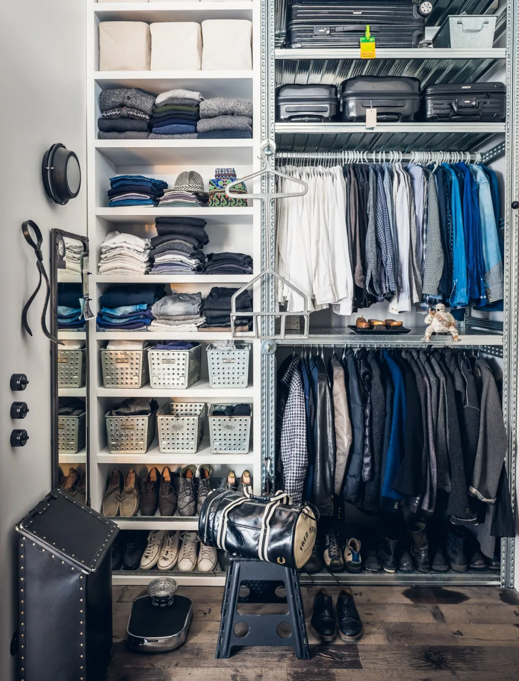 Open wardrobe with folded clothes, shirts and suitcases at Daniel Rozensztroch's Paris home
