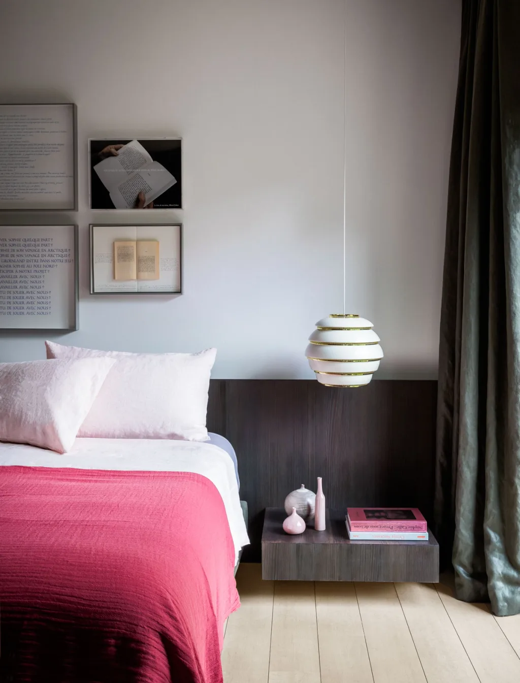 Pink-covered bed with a floating bedside shelf and striped pendant lamp, Olivier Dwek, Paris