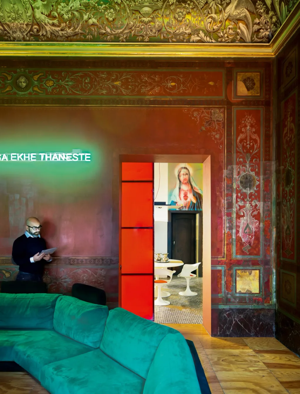 Green sofa beneath an ornate painted ceiling in the Antonio G. Martiniello interior, Naples