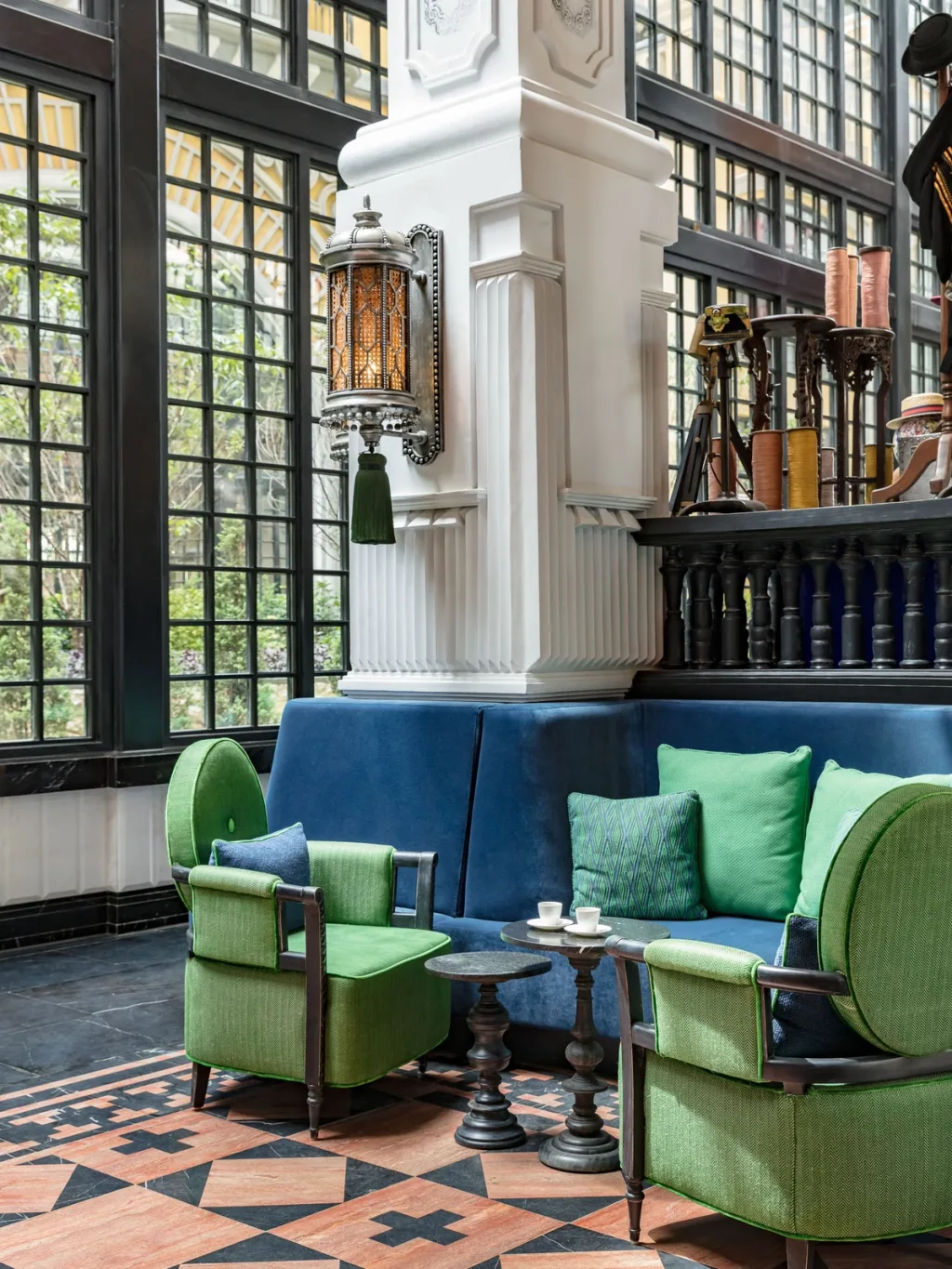 Green velvet armchairs and a blue banquette under an ornate lantern, Hotel de la Coupole MGallery, Sapa, Vietnam