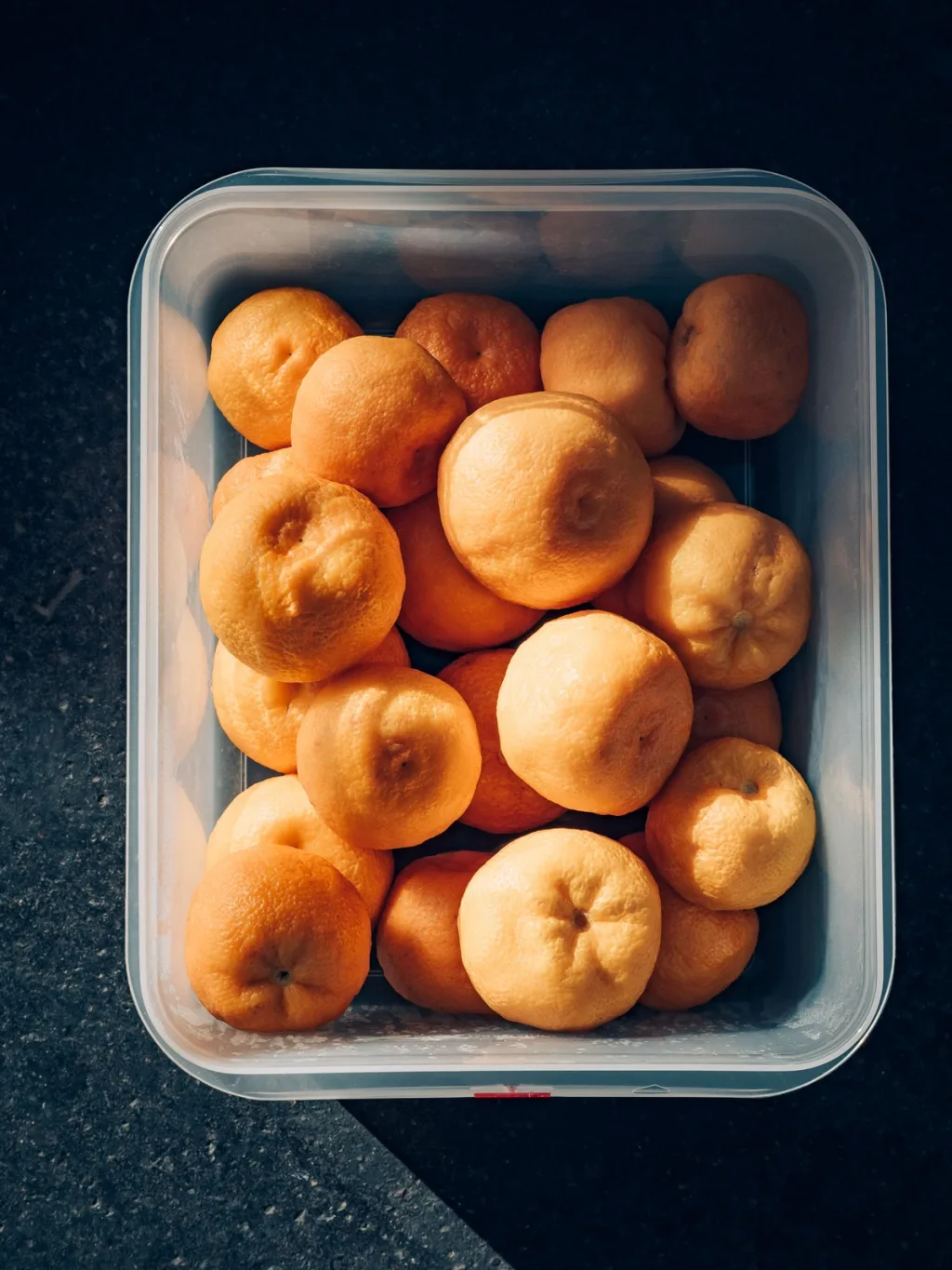 A tub of small orange citrus fruit seen from above for Cyril Lignac’s Saisons cookbook