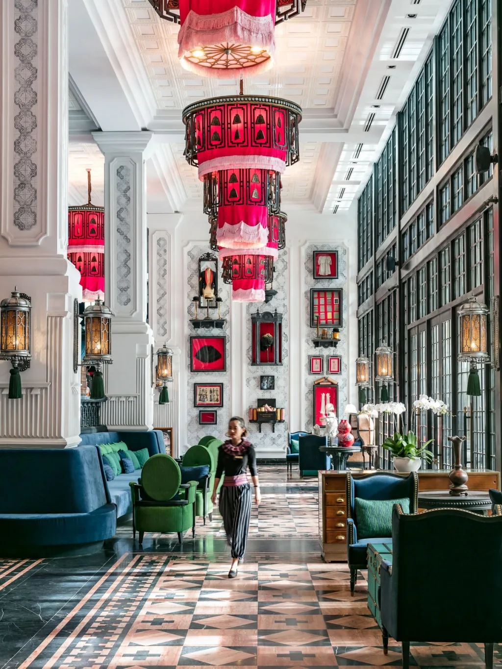 Tiered red lanterns hang above a marble hallway lined with green sofas, Hotel de la Coupole MGallery, Sapa, Vietnam