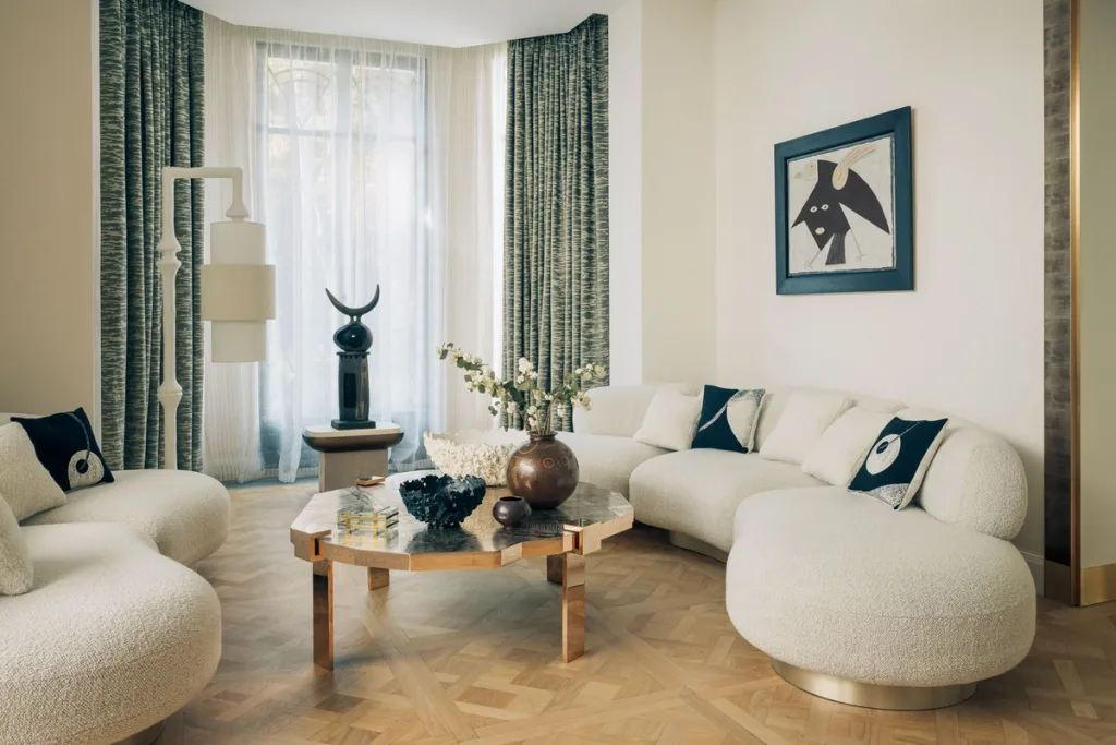 Rounded white seating around a geometric table in Stéphanie Coutas' Paris interior