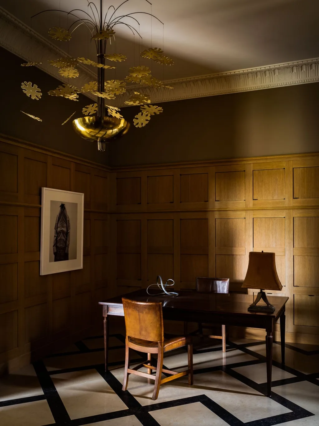 Desk and sculptural chandelier in a panelled study at Fabrègues, Pierre Yovanovitch