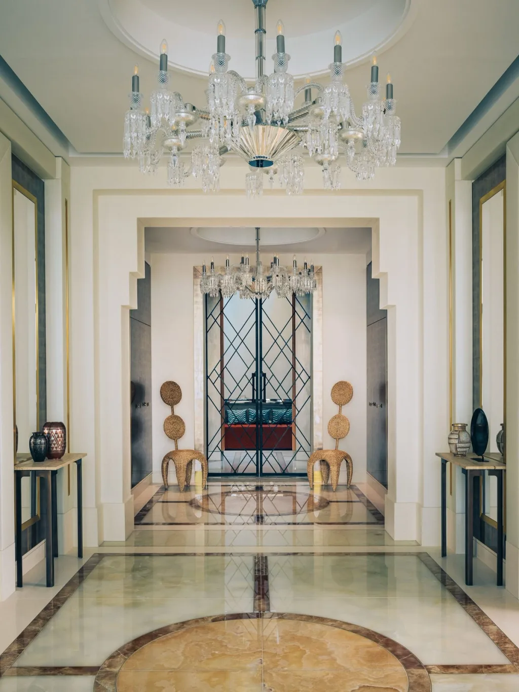 Chandeliers above a patterned entrance floor in Stéphanie Coutas' Paris interior