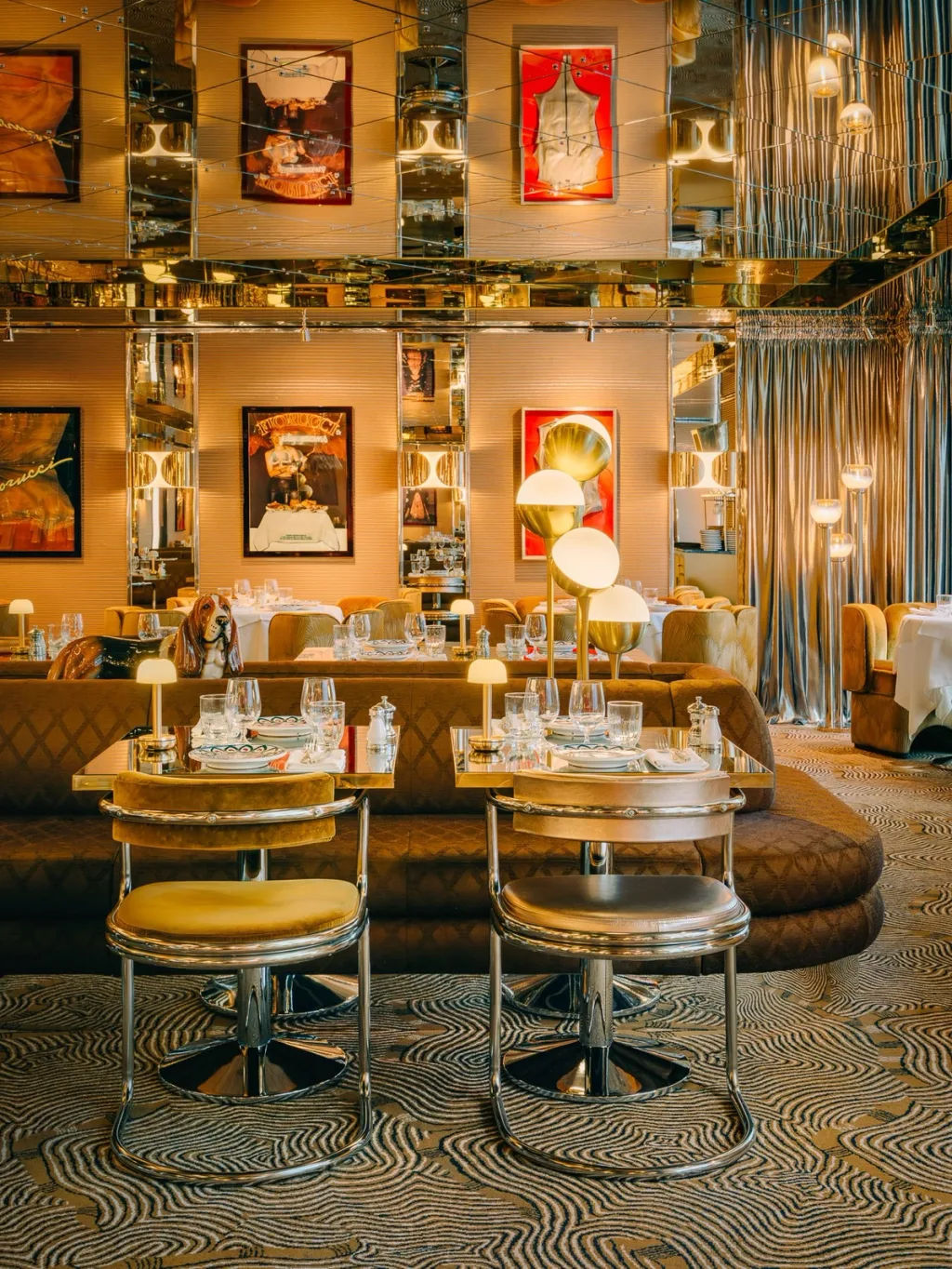 Curved booths and tubular dining chairs beneath mirrored ceiling panels at Big Mamma, UK