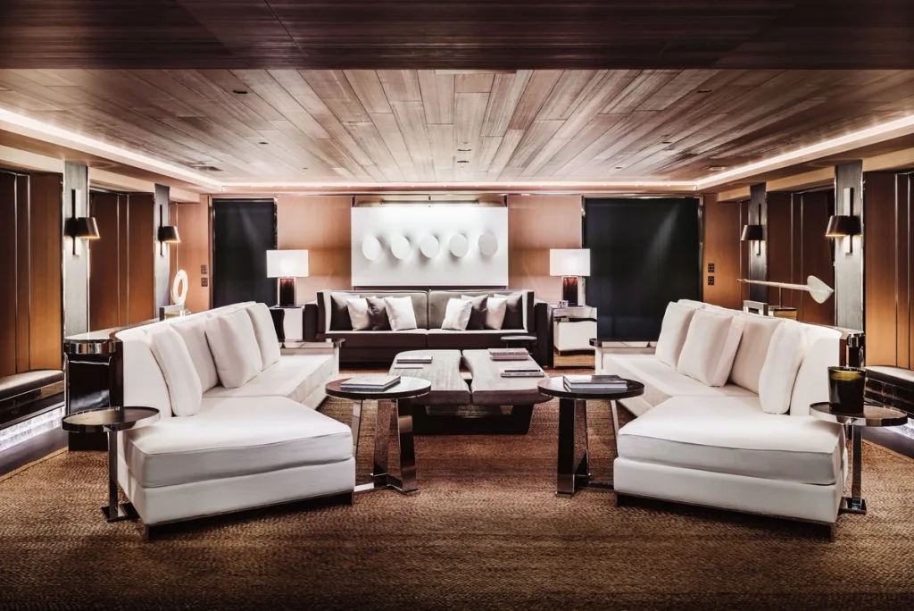Symmetrical white sofas and dark tables in Atlante's wood-panelled main lounge