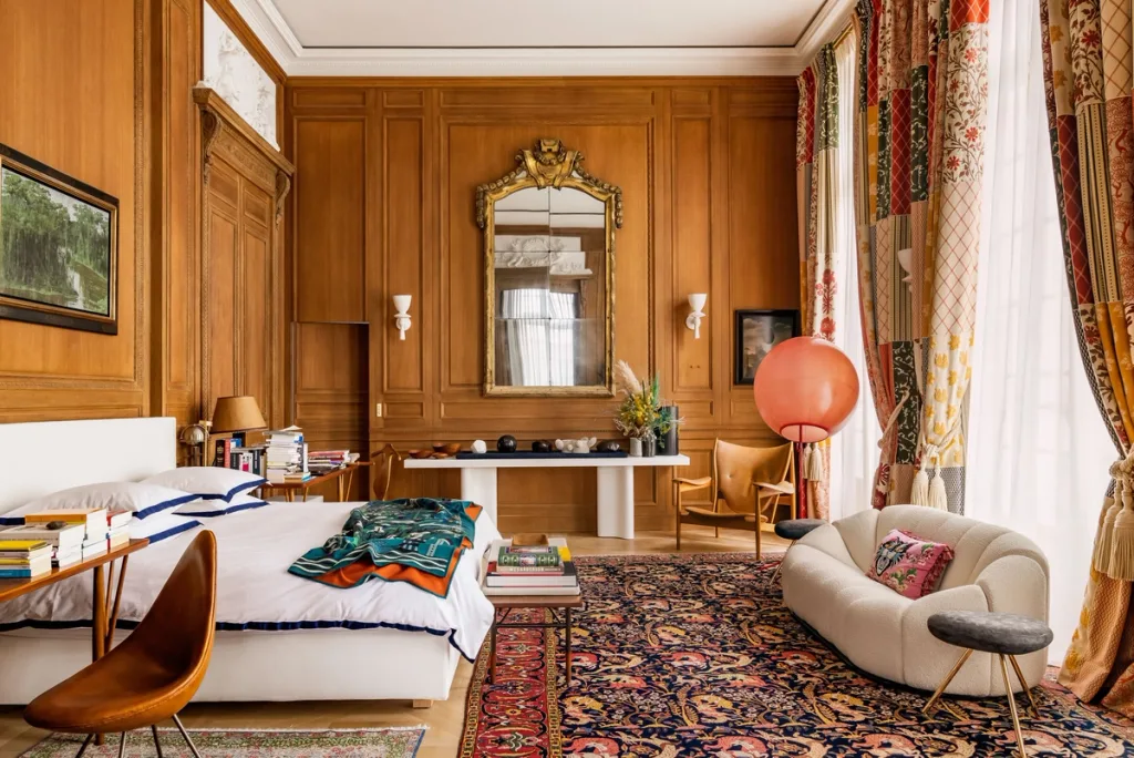 Wood-panelled bedroom with patterned curtains in Laurent Buttazzoni's Paris interior