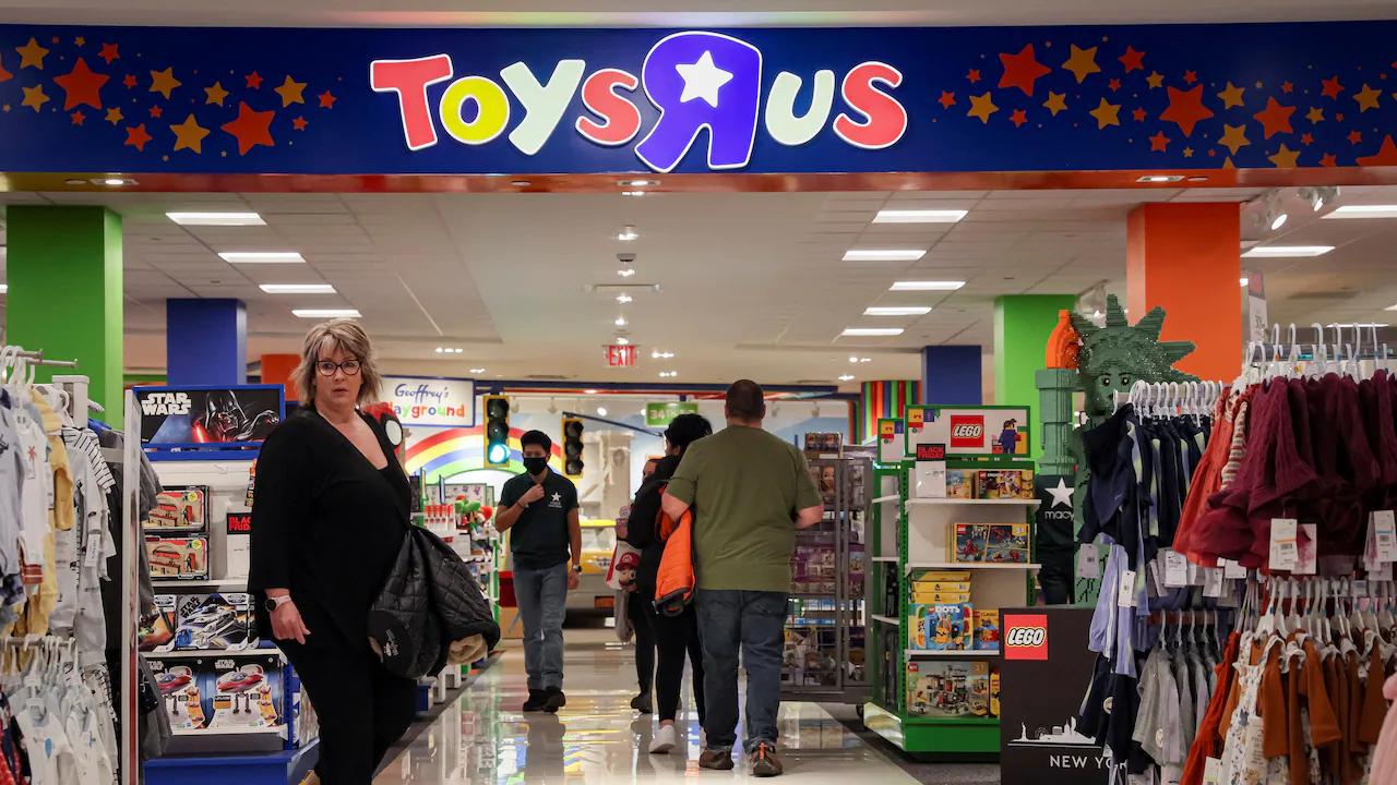 Shoppers walking inside a Toys R Us store