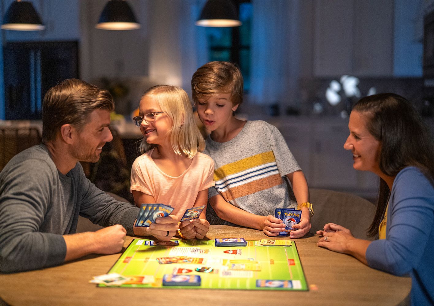 Children and adults playing the Pokémon Trading Card Game together