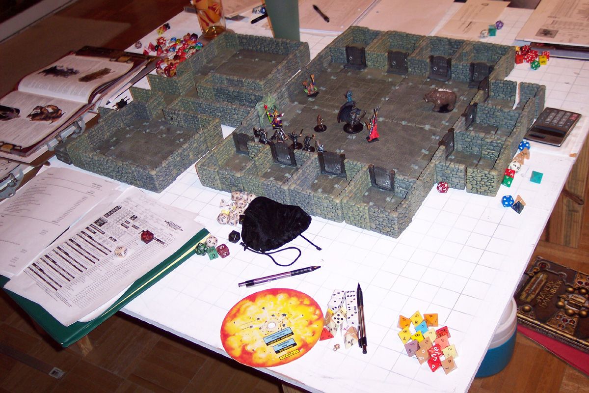 Dungeons and Dragons tabletop session with miniatures, terrain, and dice
