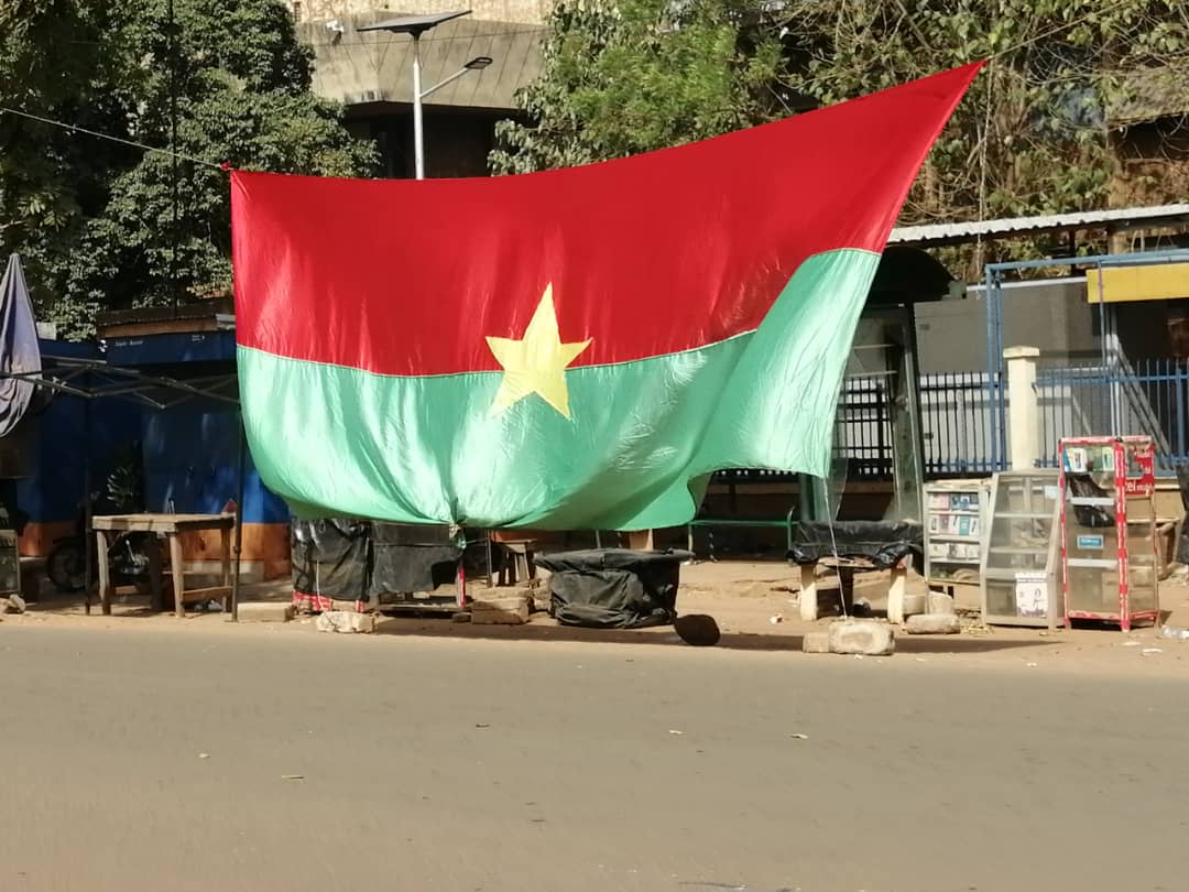Burkina Faso national flag displayed over a street in Ouagadougou (photo: EKokou, Wikimedia Commons, CC BY-SA 4.0)