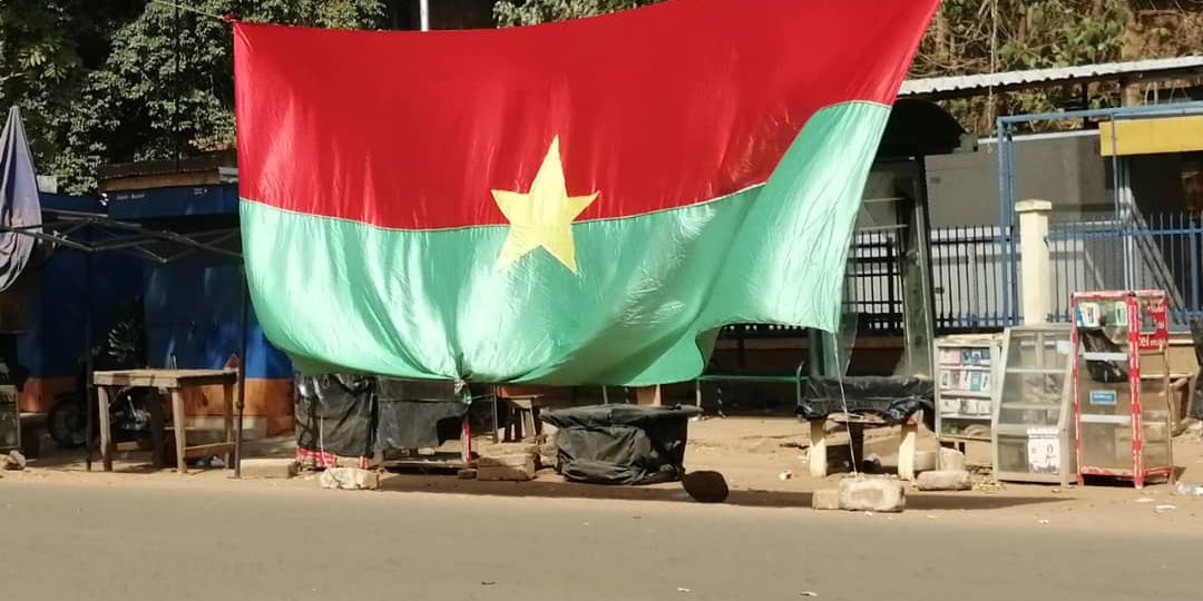 Burkina Faso national flag displayed over a street in Ouagadougou (photo: EKokou, Wikimedia Commons, CC BY-SA 4.0)
