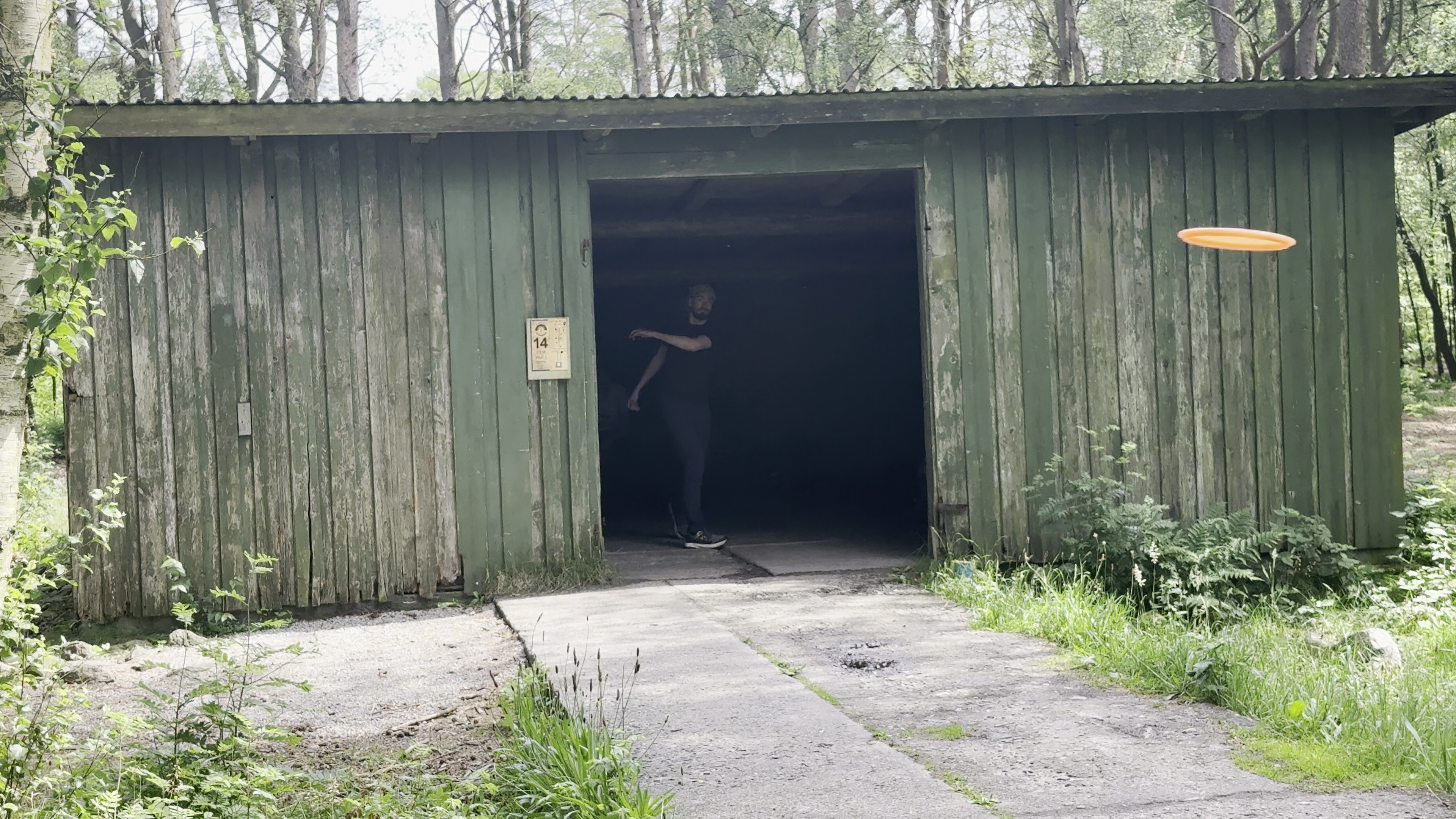 Man throwing disc out from building