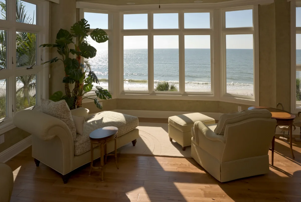Salon avec baie vitrée donnant sur la mer