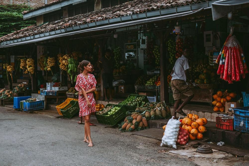 Girl looking at fruits at a Sri Lankan market wearing Nangi rings