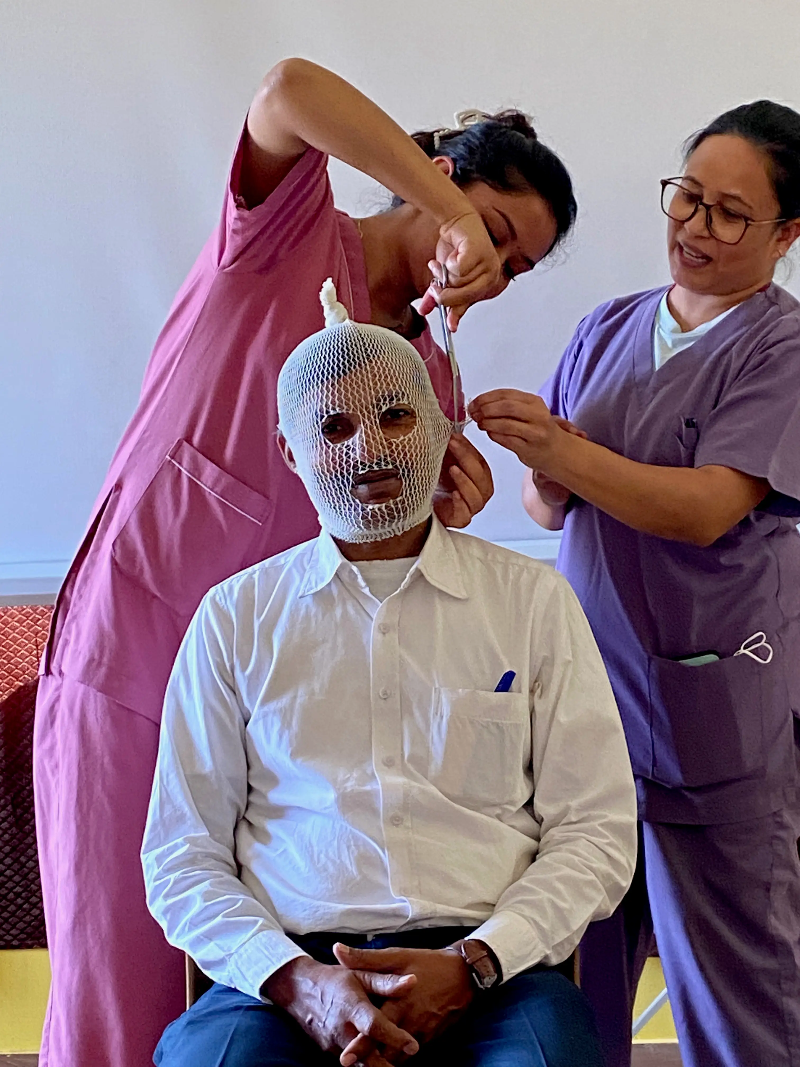 Participants at a burn injuries training in Kathmandu practise bandaging, in October 2024.