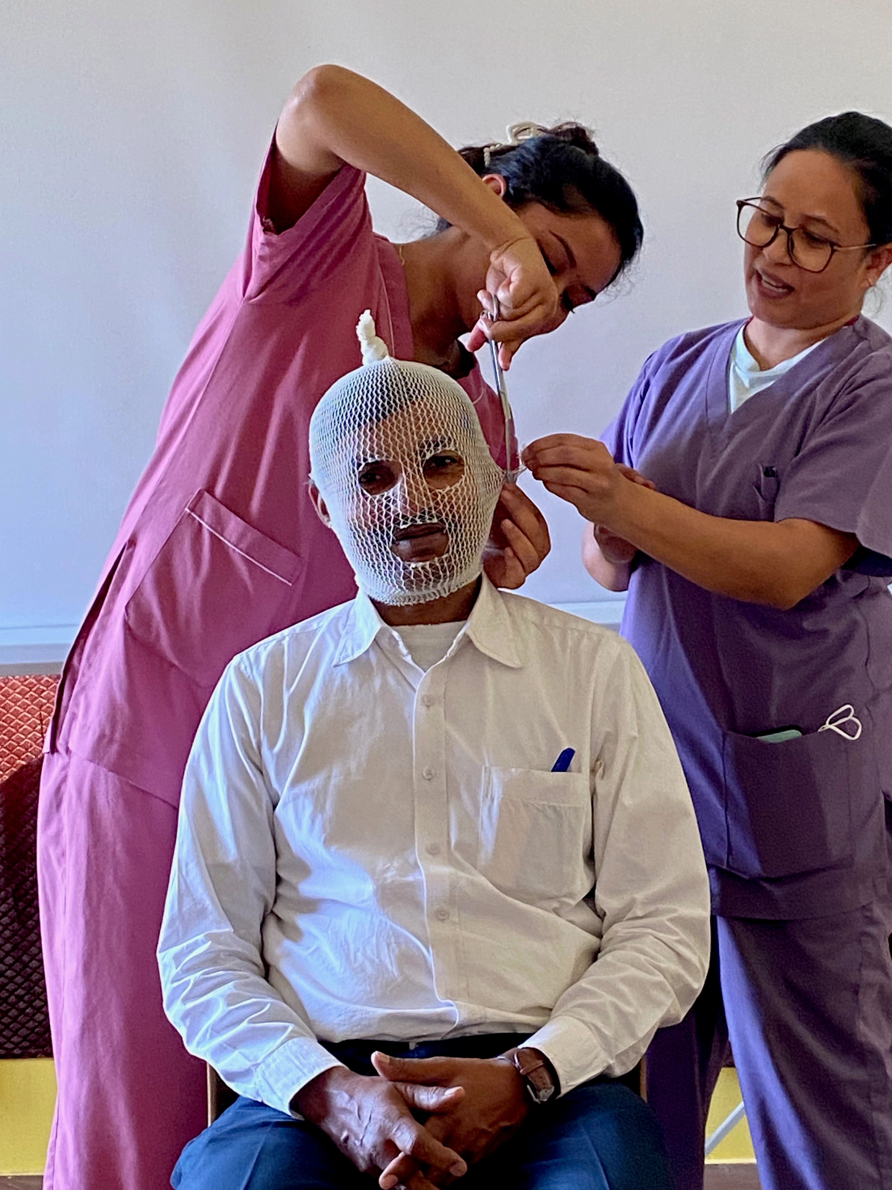 Participants at a burn injuries training in Kathmandu practise bandaging, in October 2024.