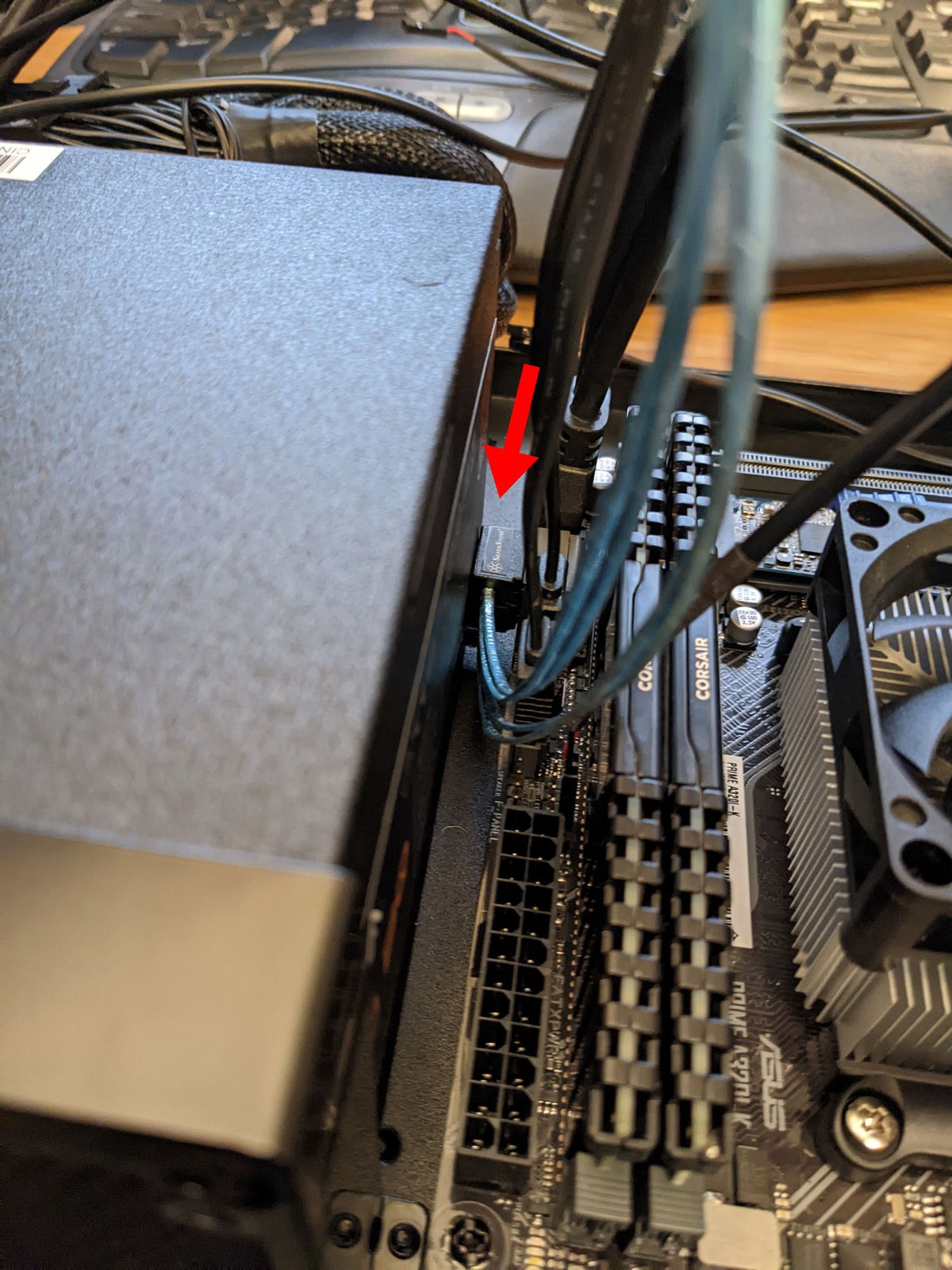 Photo of 90-degree SATA cable just barely fitting between the SATA port and the power supply