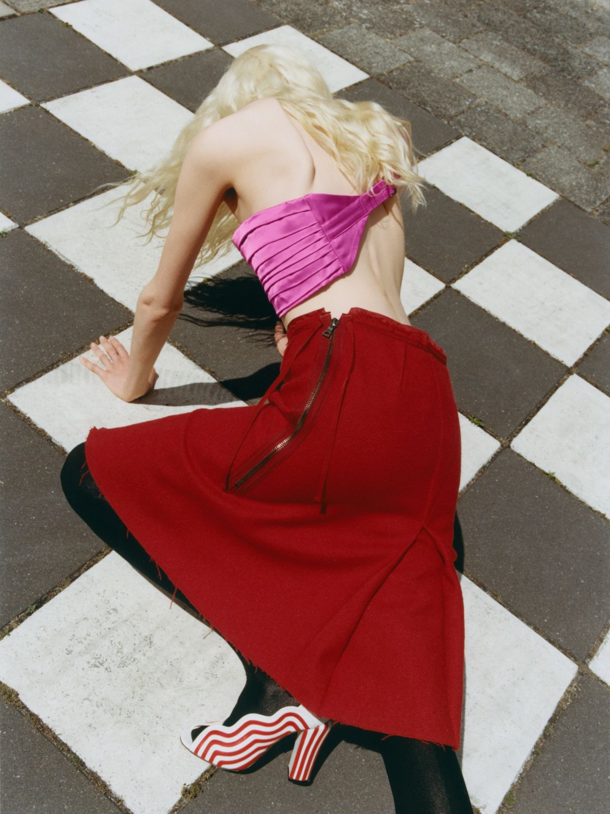 Women wearing pink and red climbing across a crossing
