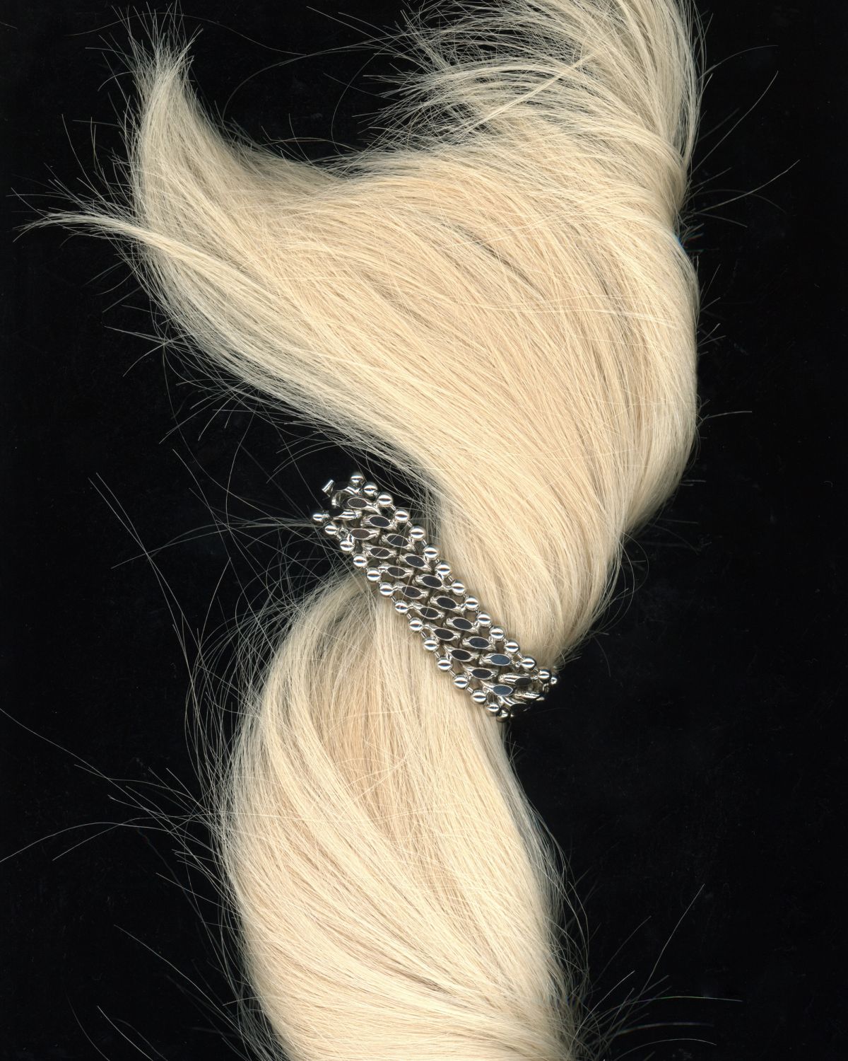 Blonde hair with sliver bracelet put through a scanner