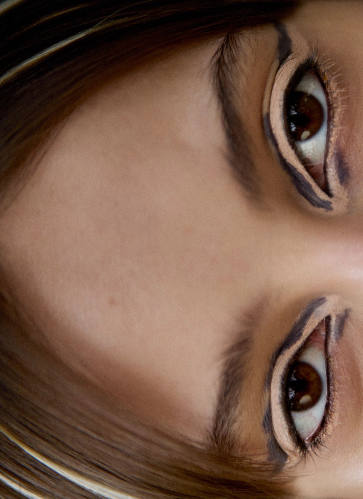extreme close up of models eyes and graphic smudged eye liner