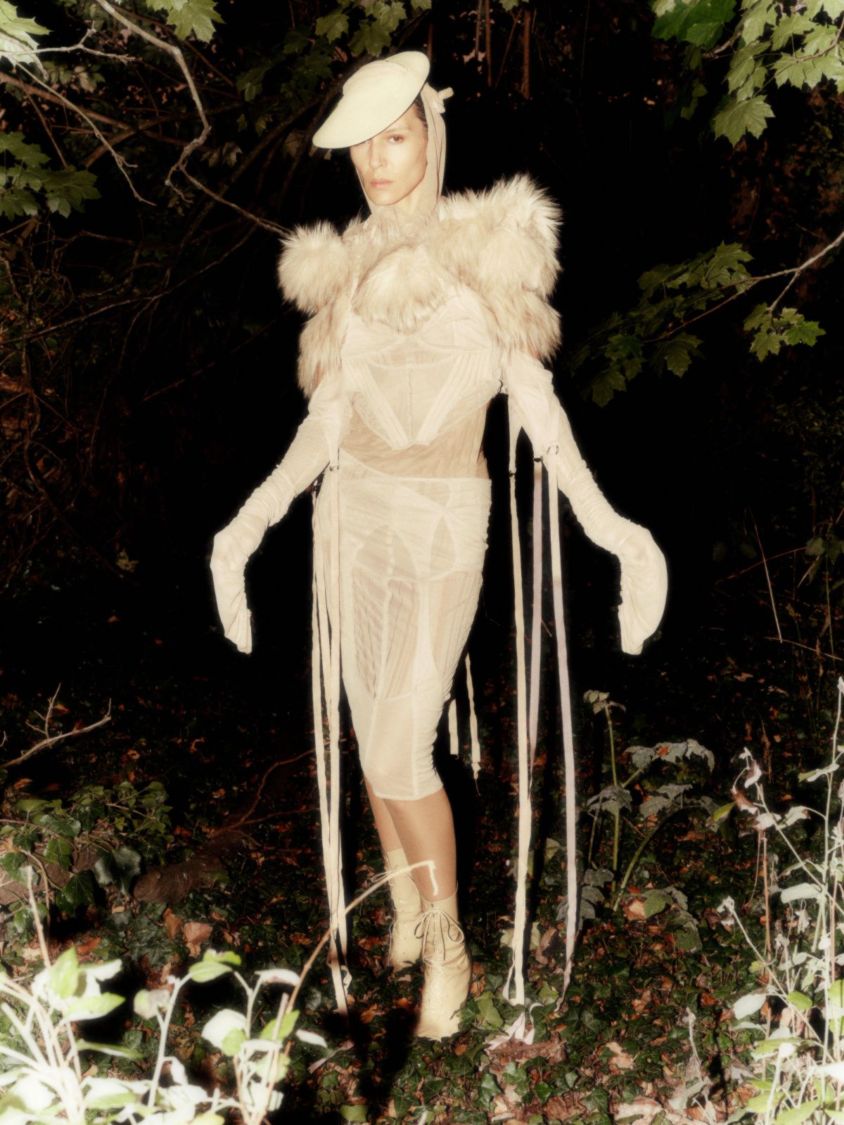 models wearing cream standing in the bushes at night