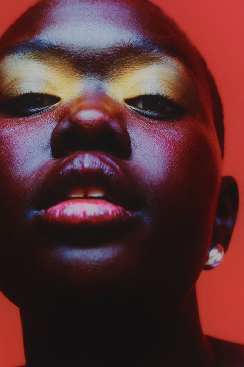 Model on red back ground with yellow eyeshadow