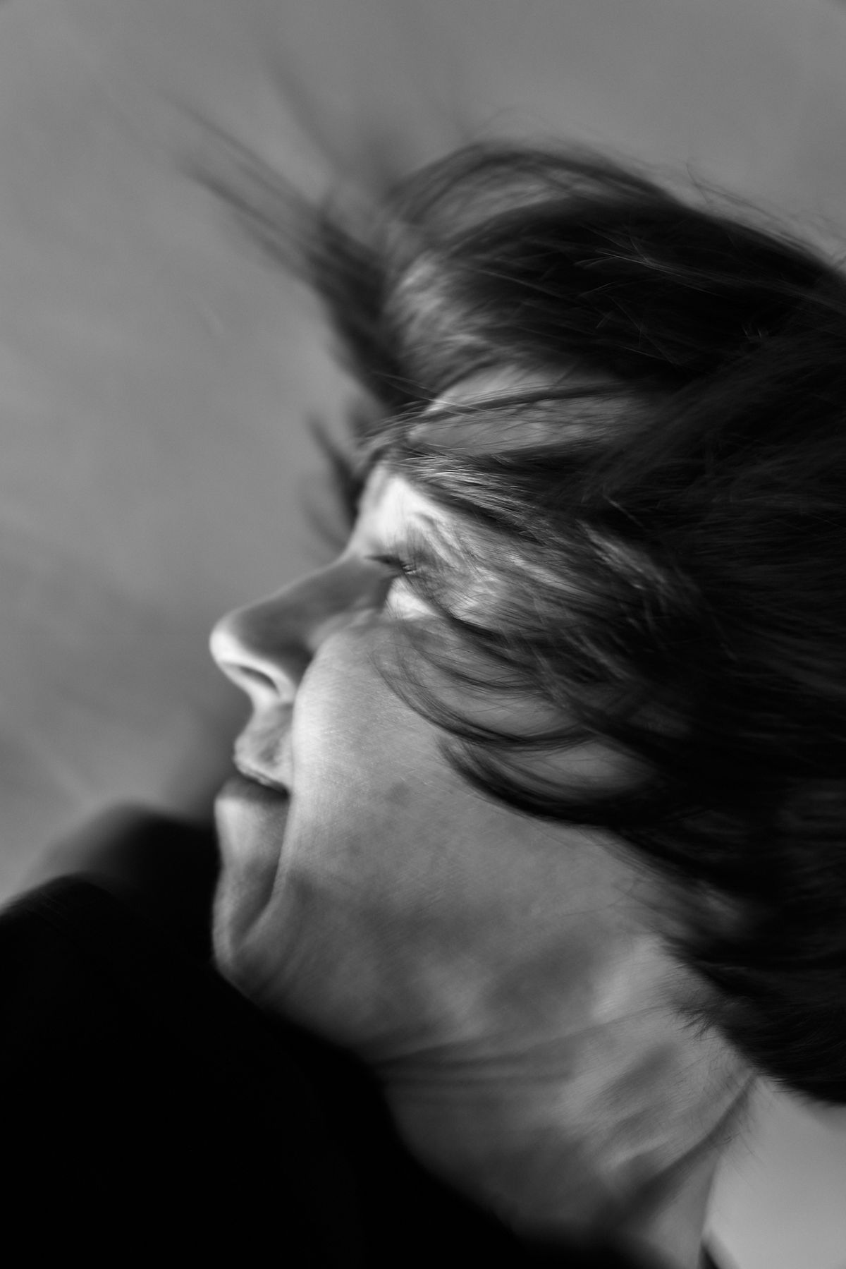 black and white close up of a women with soft movement in the hair