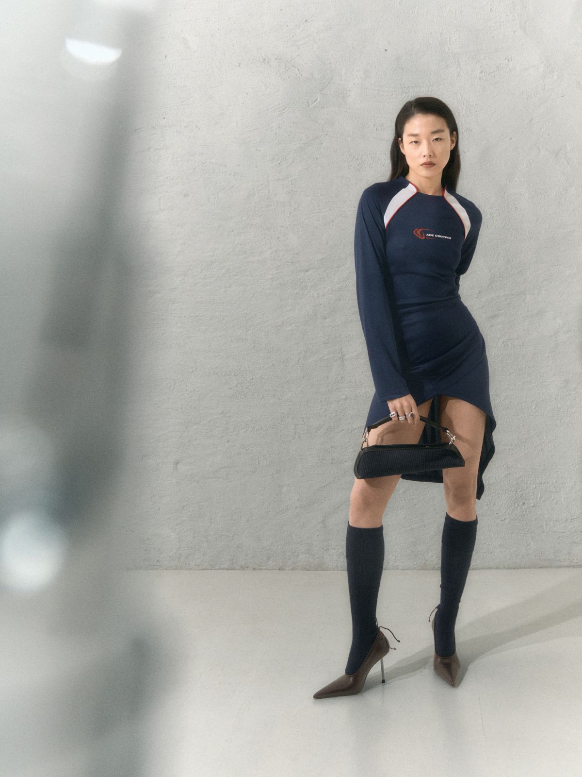 model posing with objects in the foreground