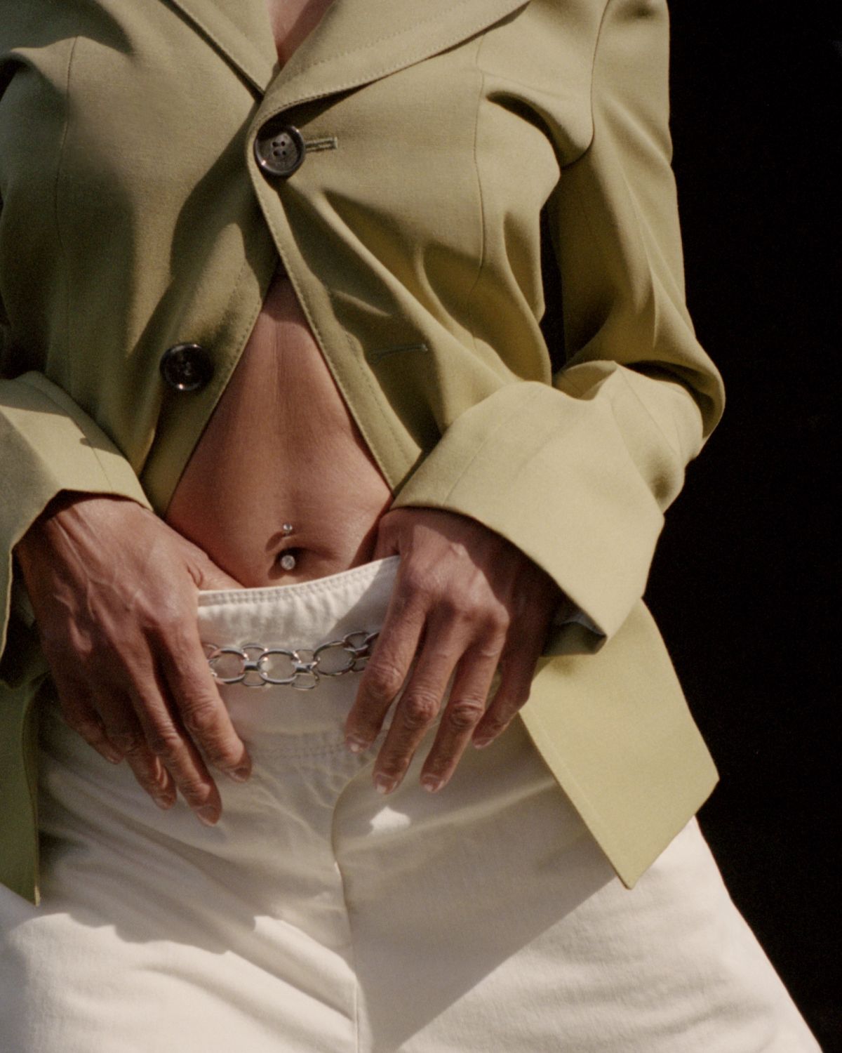 Cropped shot of models stomach on black background