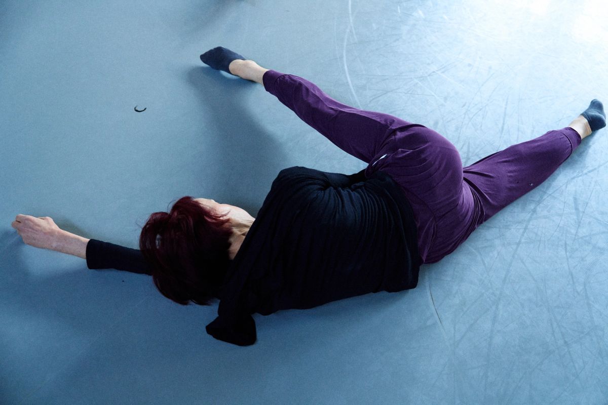 women stretching arms and legs on the floor