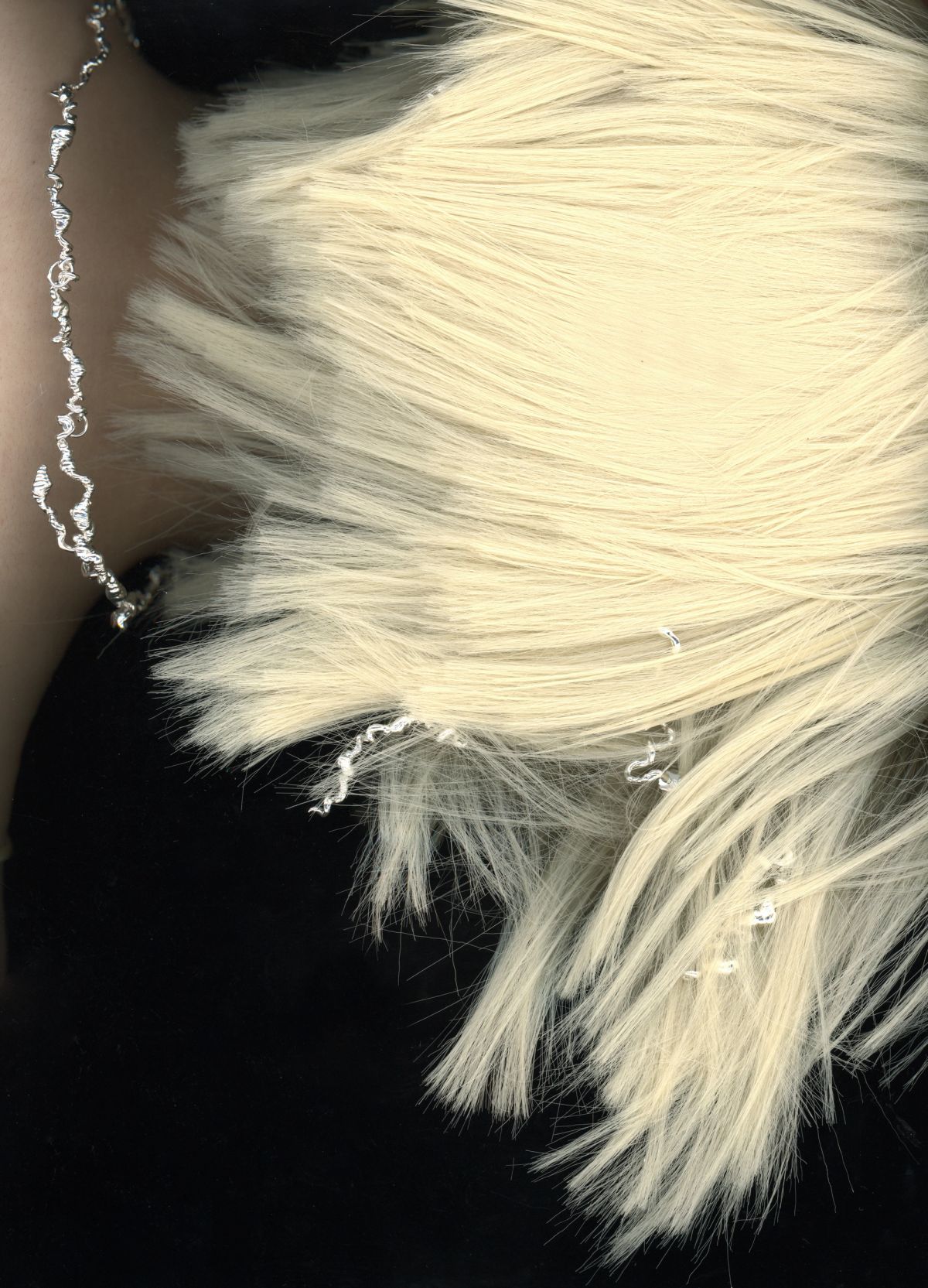 scan of the back of a models head with blonde wig