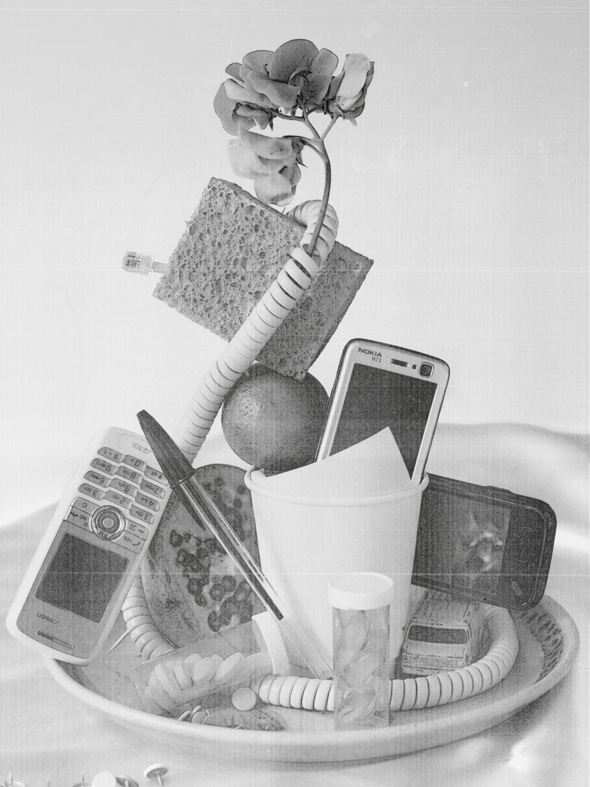 still life household objects and phones all balanced