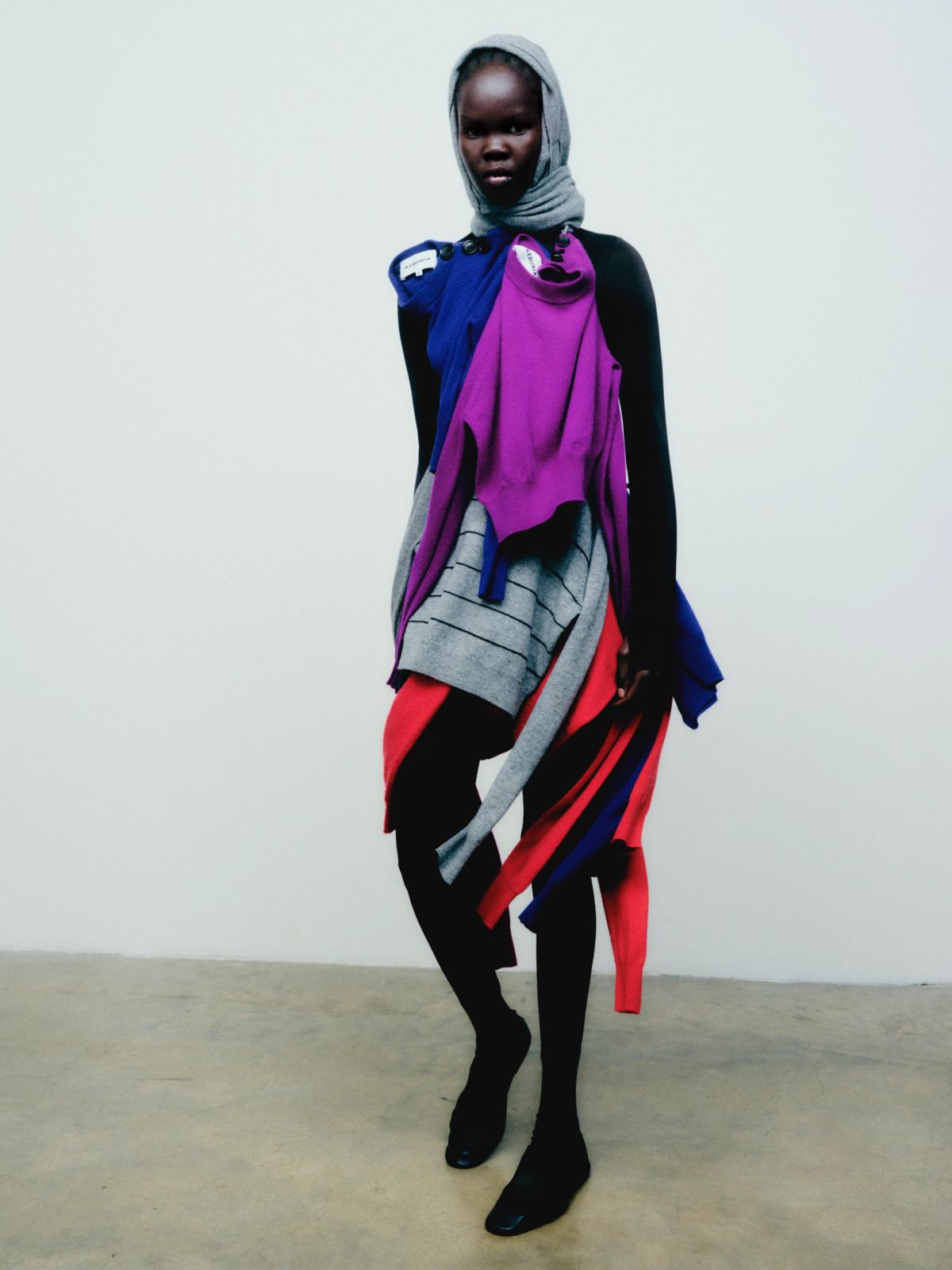 model facing camera with cardigans drapped across the body