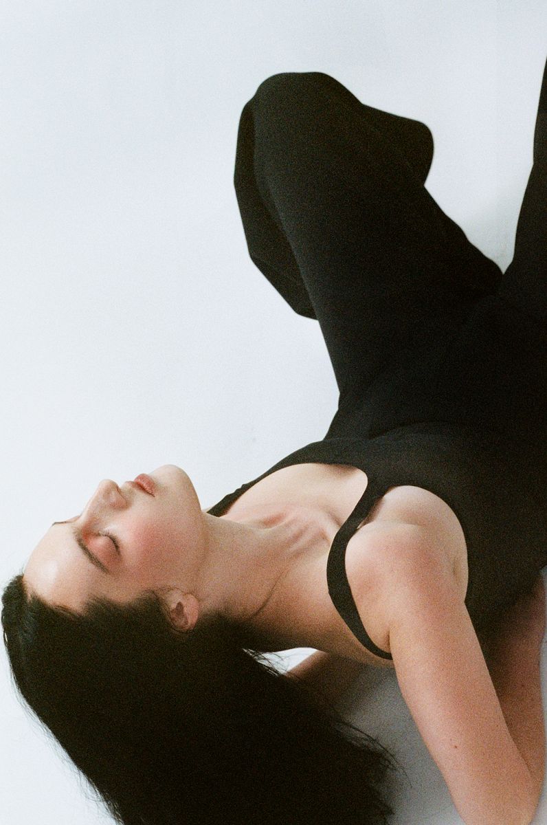 model upside down in black top and trousers