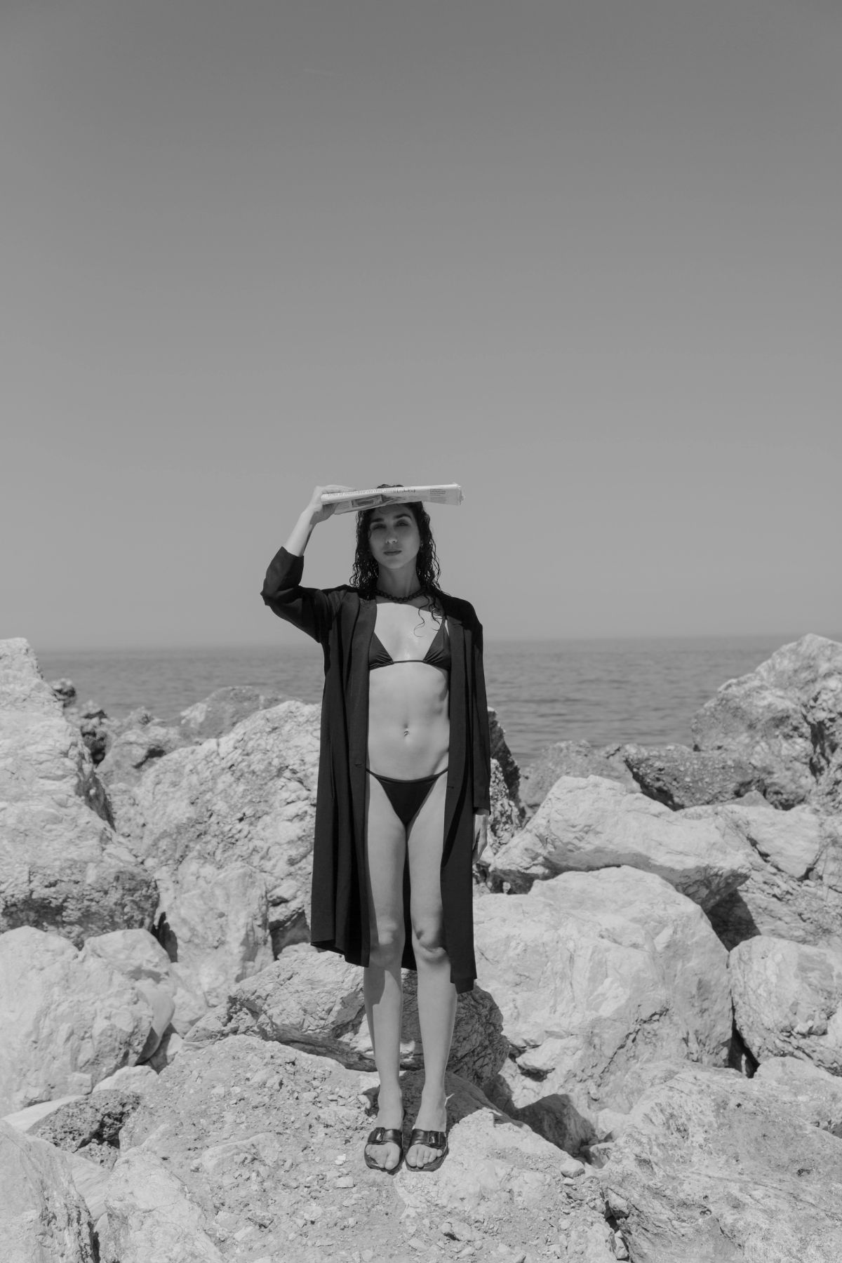 Woman standing on rocks in bikini