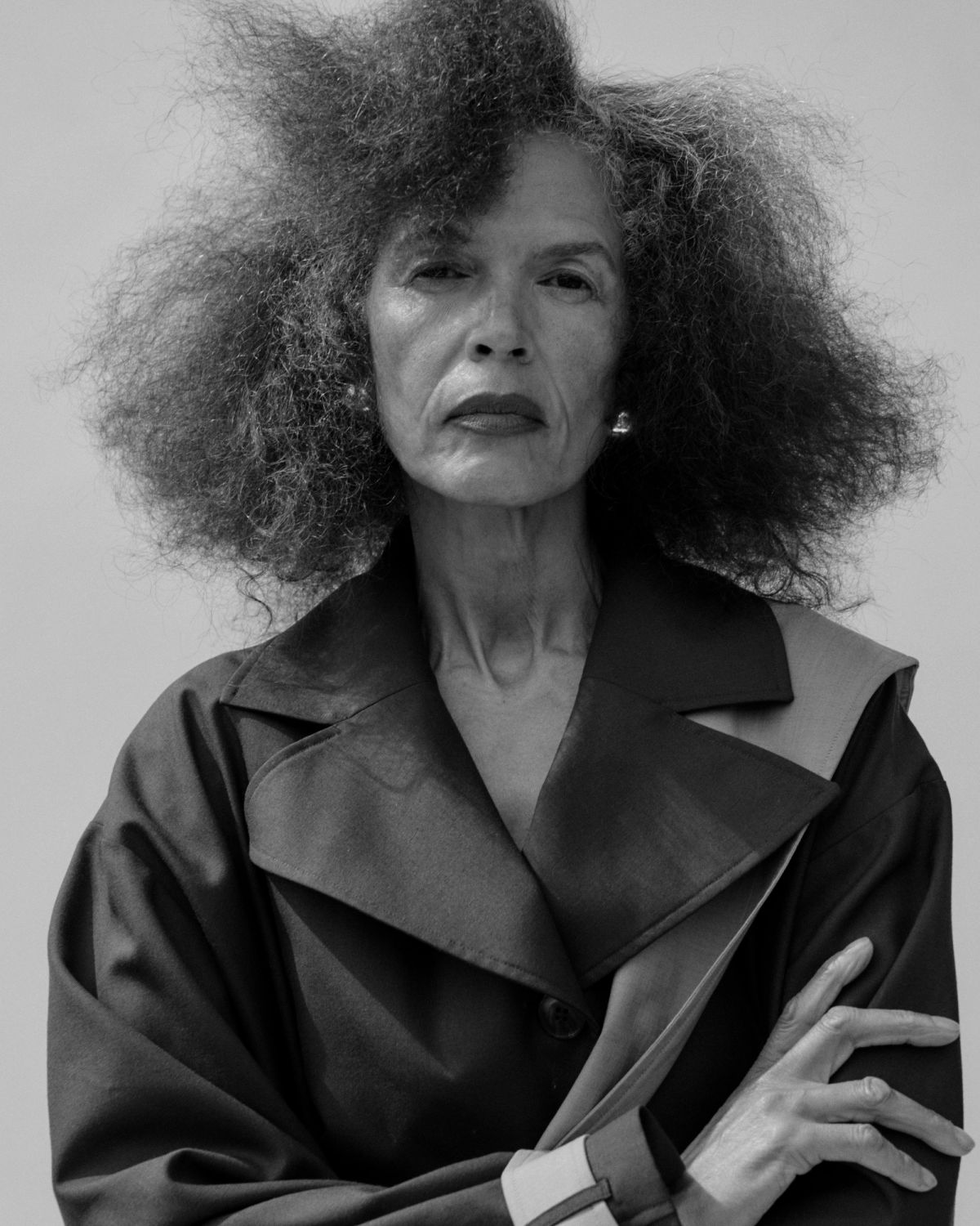 cropped portrait of model in trench coat