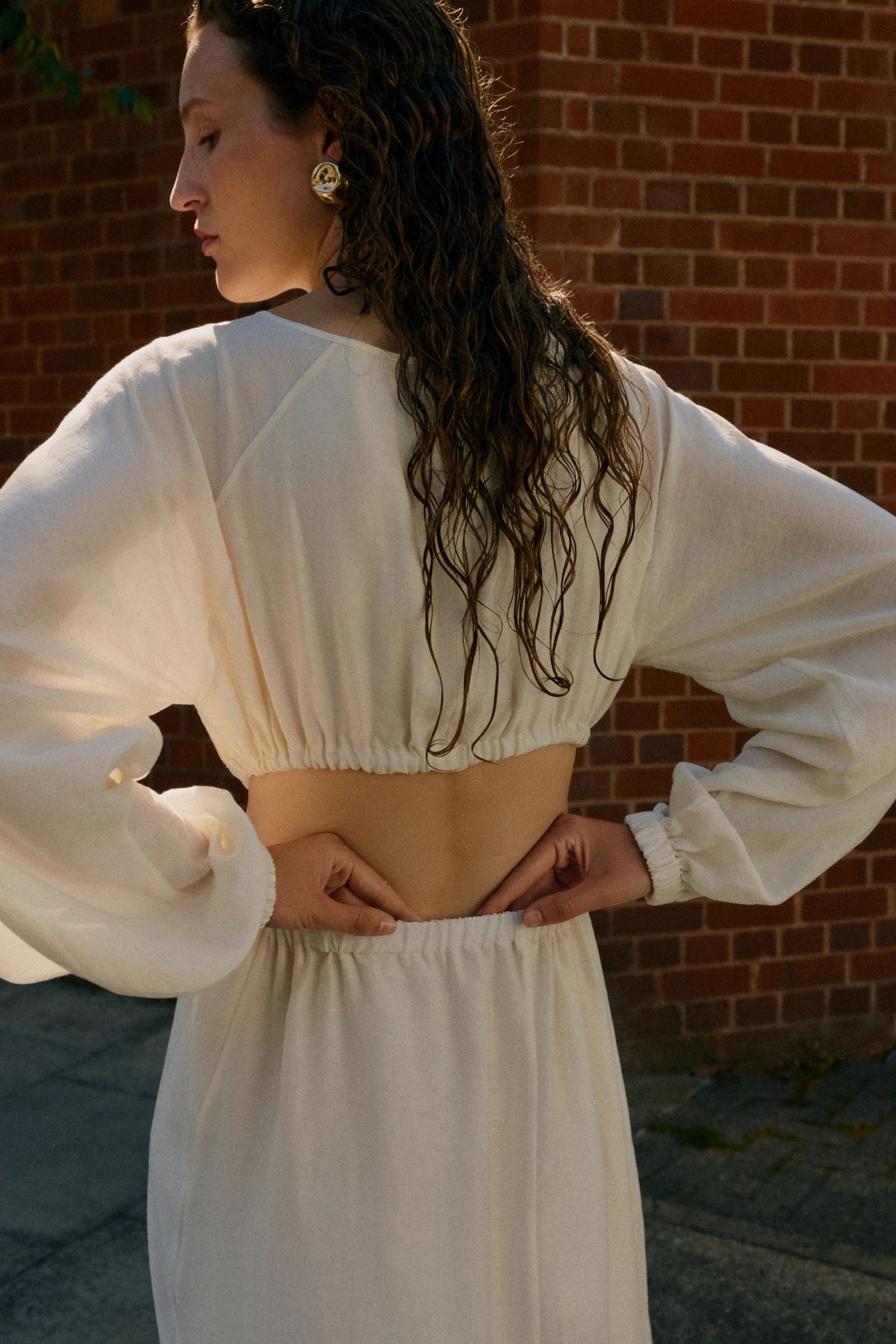 Woman facing backwards in white dress