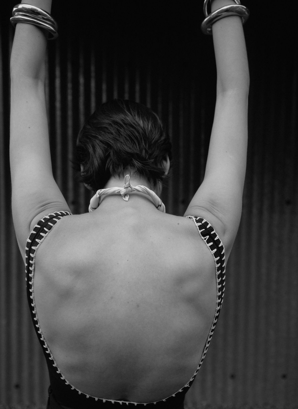 image of models back wearing a swimsuit with blanket sitiching