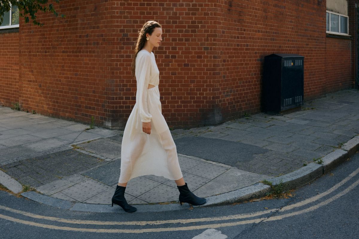 Woman walking along edge of pavement