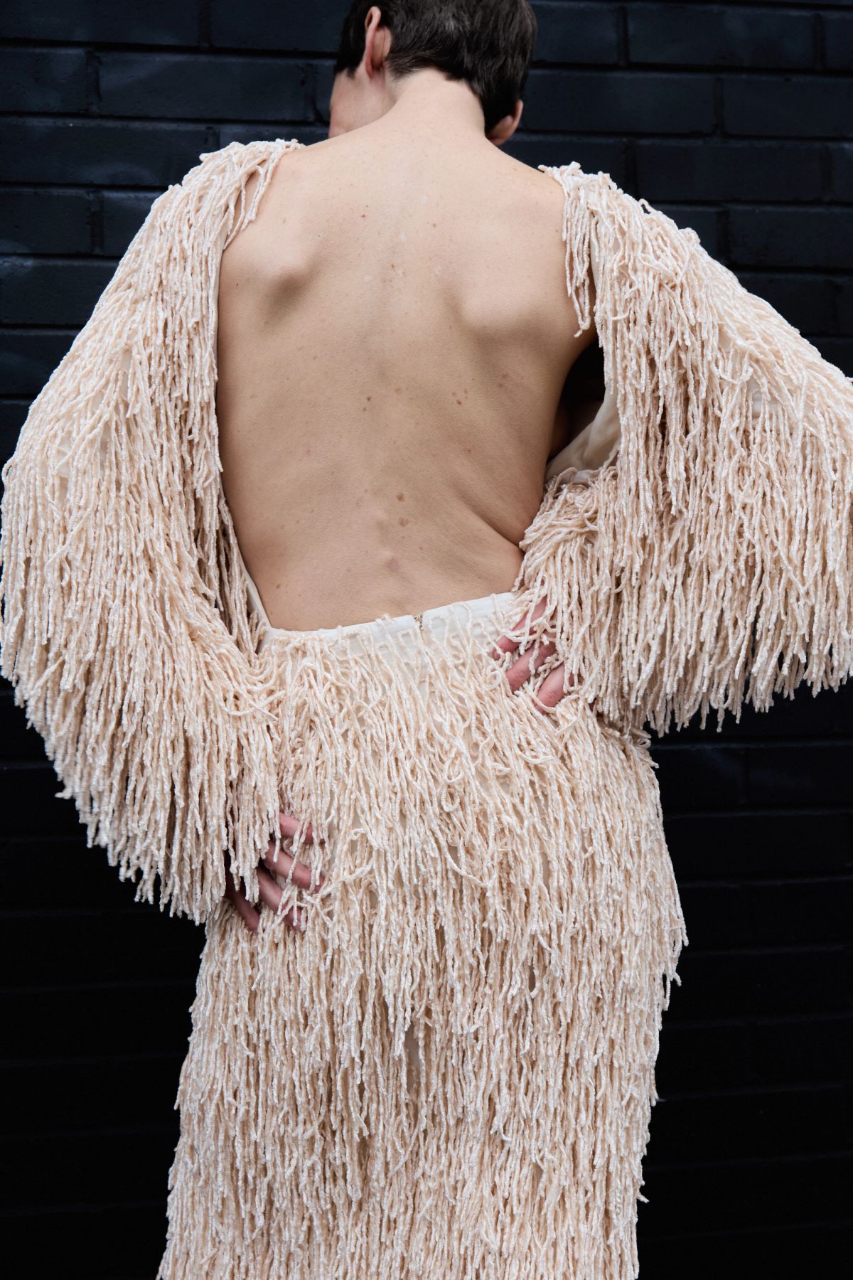 Back of model in textured dress