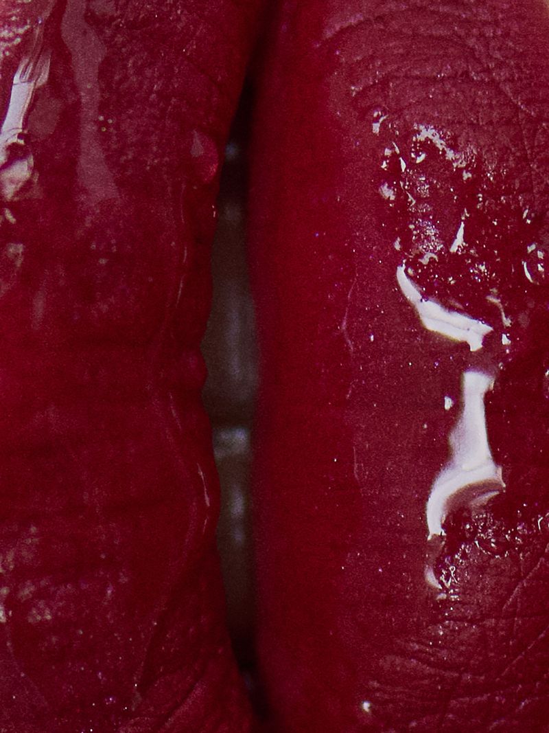 extreme close up of glossy pink lips