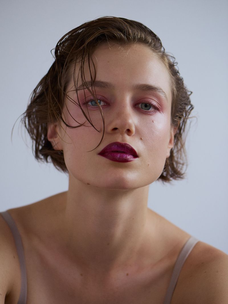 close crop of model looking to camera with ombre burgundy lipstick