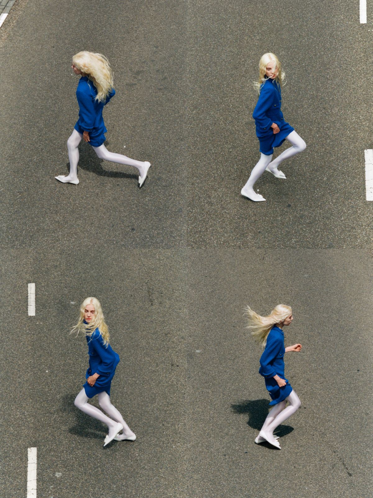 women in blue suit running across a road