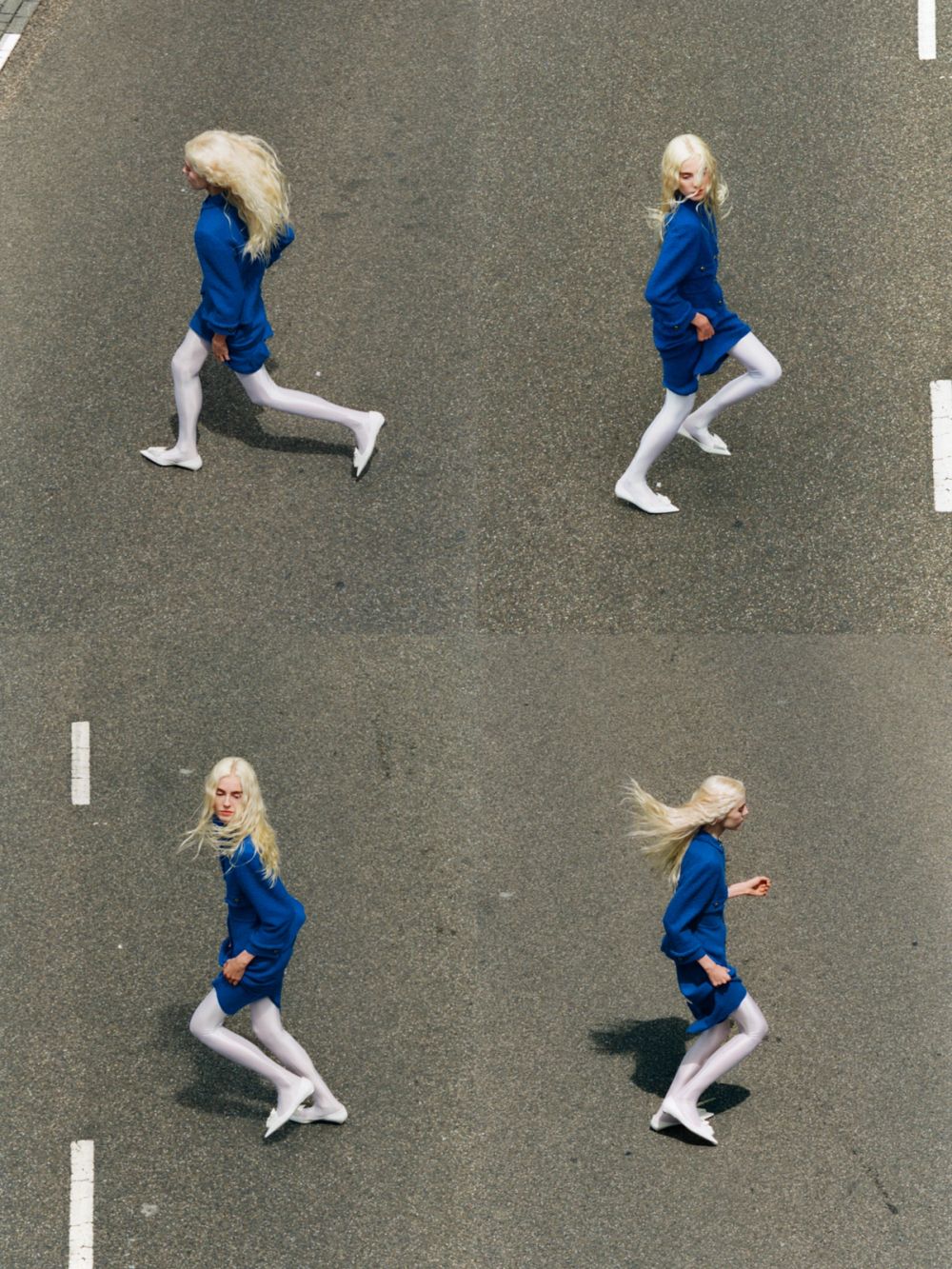 women in blue suit running across a road